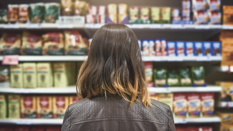 Girl looking at shelves with many brands