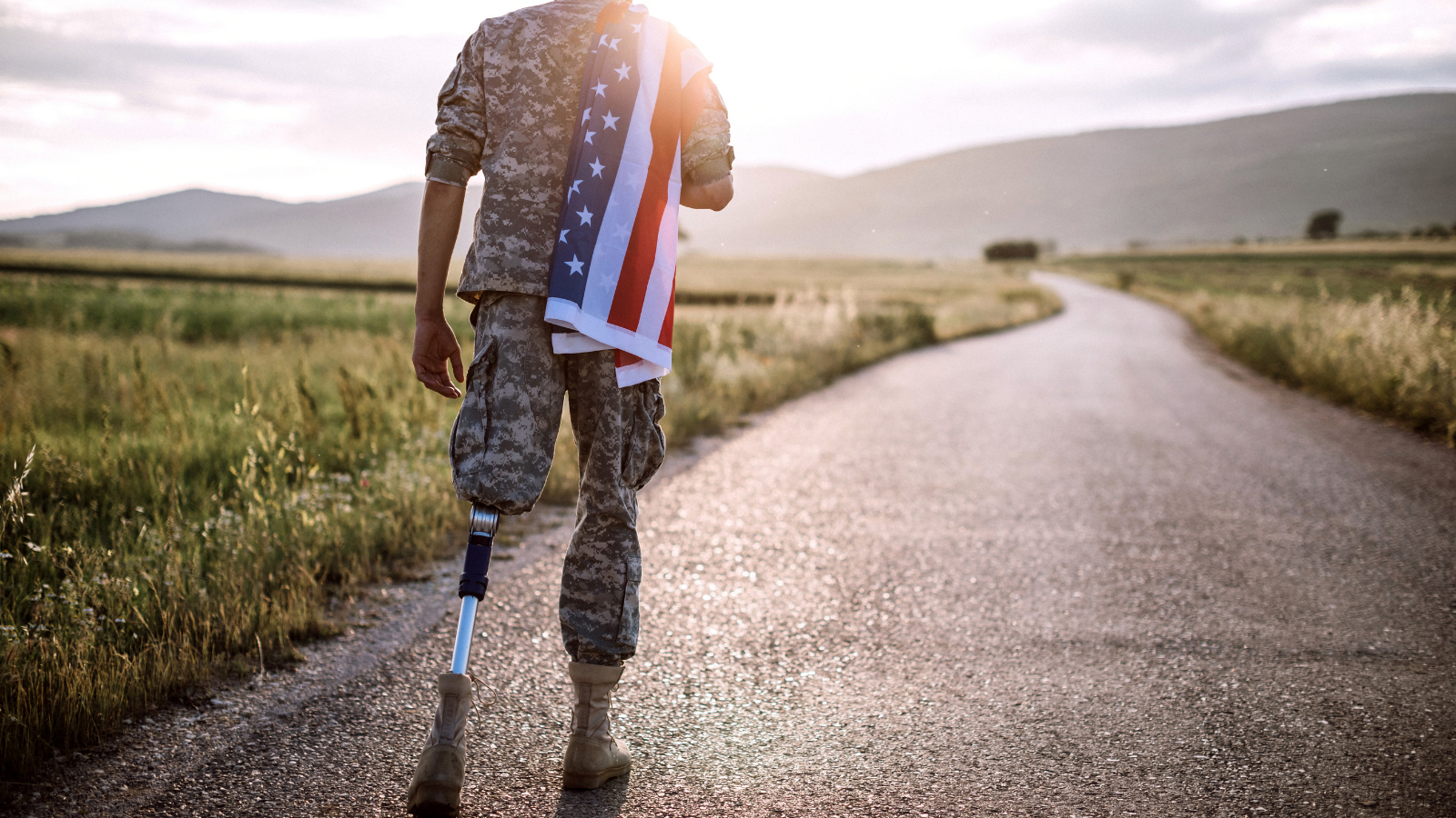 Amputee soldier walking down path