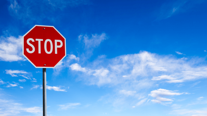 Stop sign against blue sky