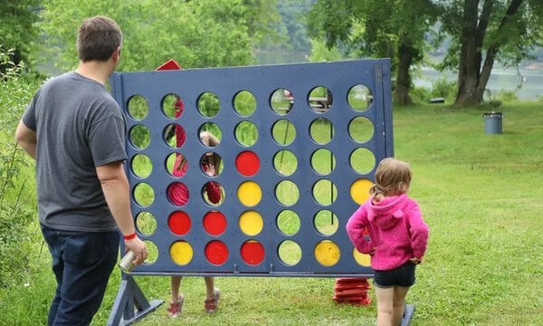 Father playing a game with his two daughters